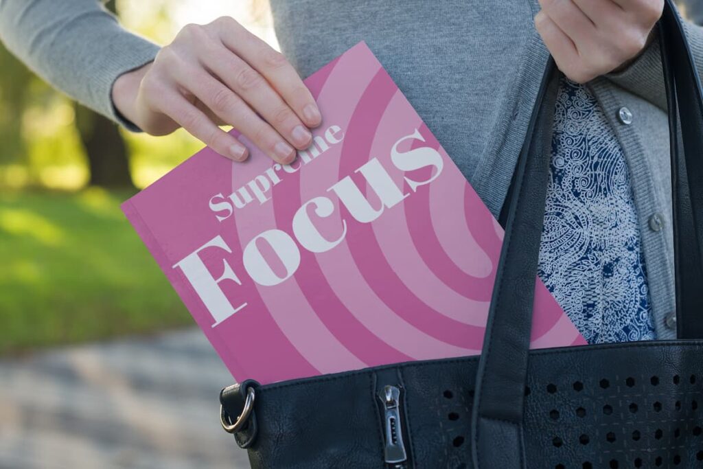 a girl holding supreme focus workbook